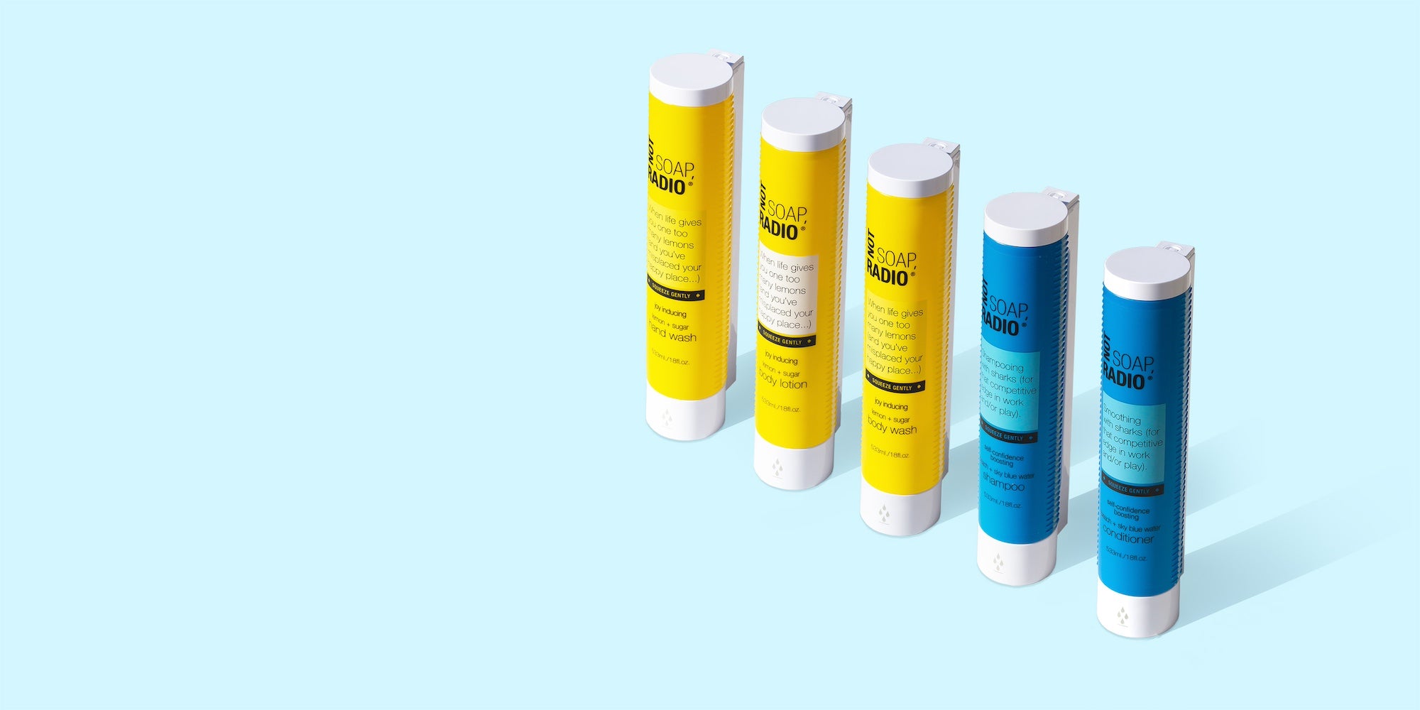 Tru hotel wall mounted hair and body care cartridges by Not Soap, Radio in a row, on a light blue background.