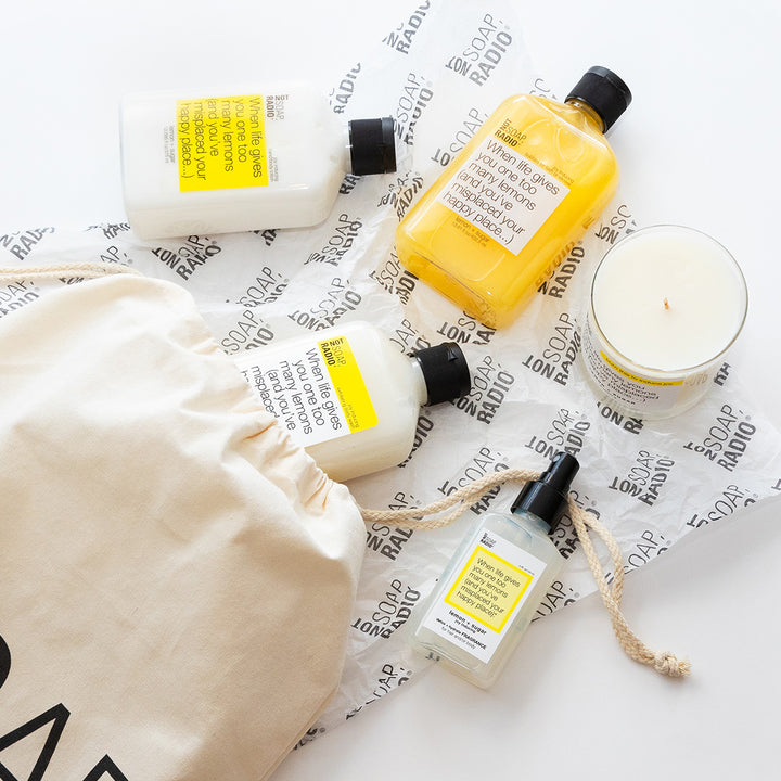 Lemon and sugar themed bath and body products coming out of a Not Soap Radio bag.