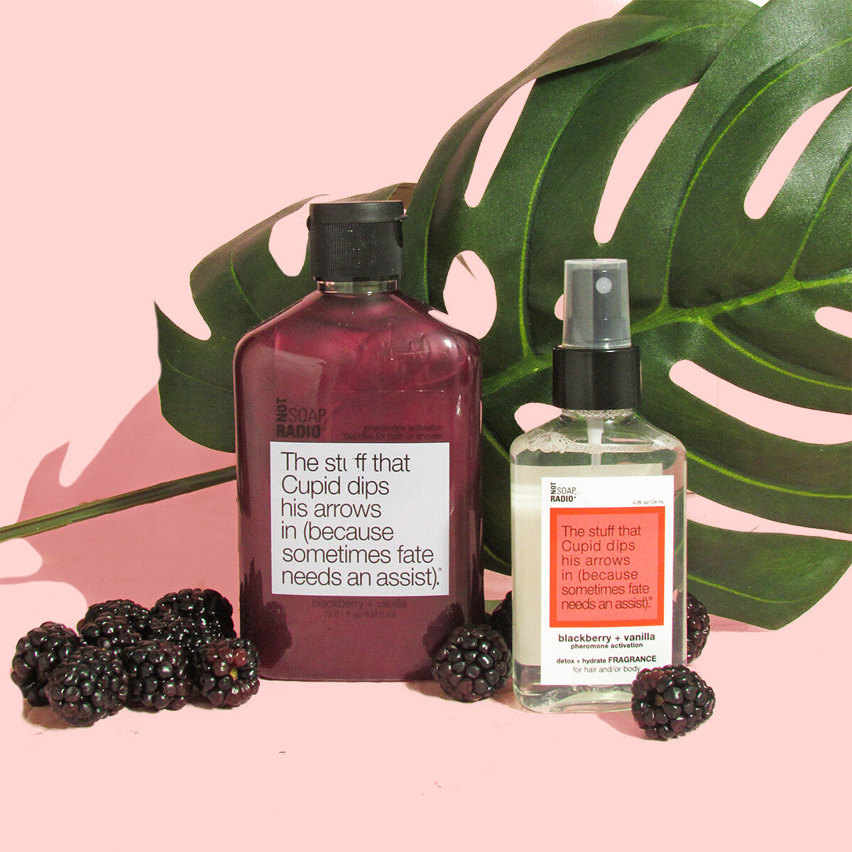 The stuff that cupid dips his arrows in bubble bath and fragrance spray, surrounded by blackberries on a pink background