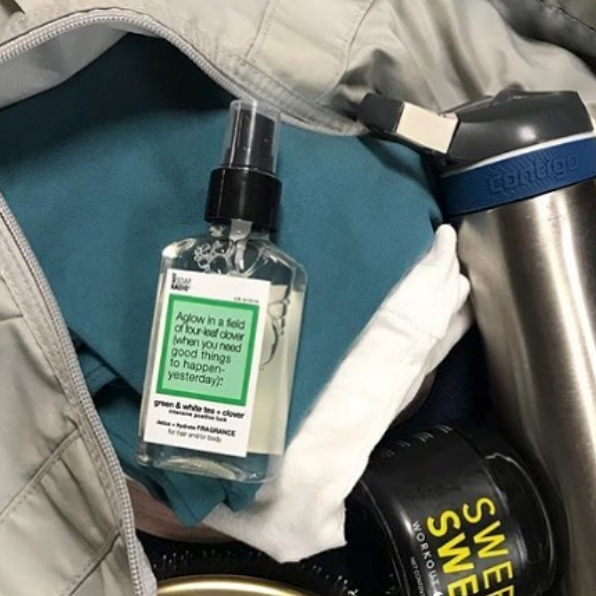 A green tea clover scented fragrance mist inside of a gym bag.