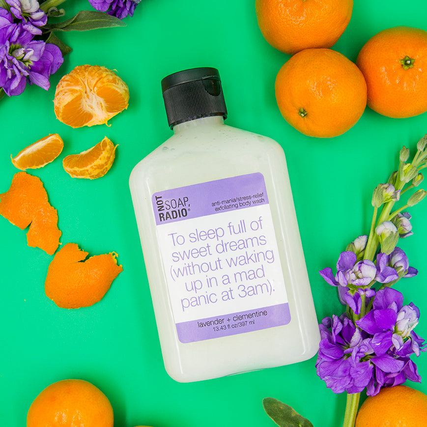 A flatlay of Not Soap Radio's "To sleep full of sweet dreams" exfoliating body wash with Lavender flowers and clementines 