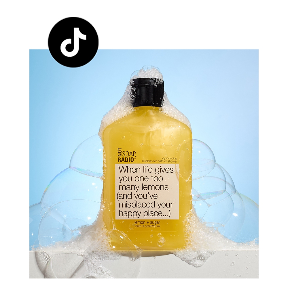 lemon sugar scented bubble bath on side of a tub, with tiktok icon in corner