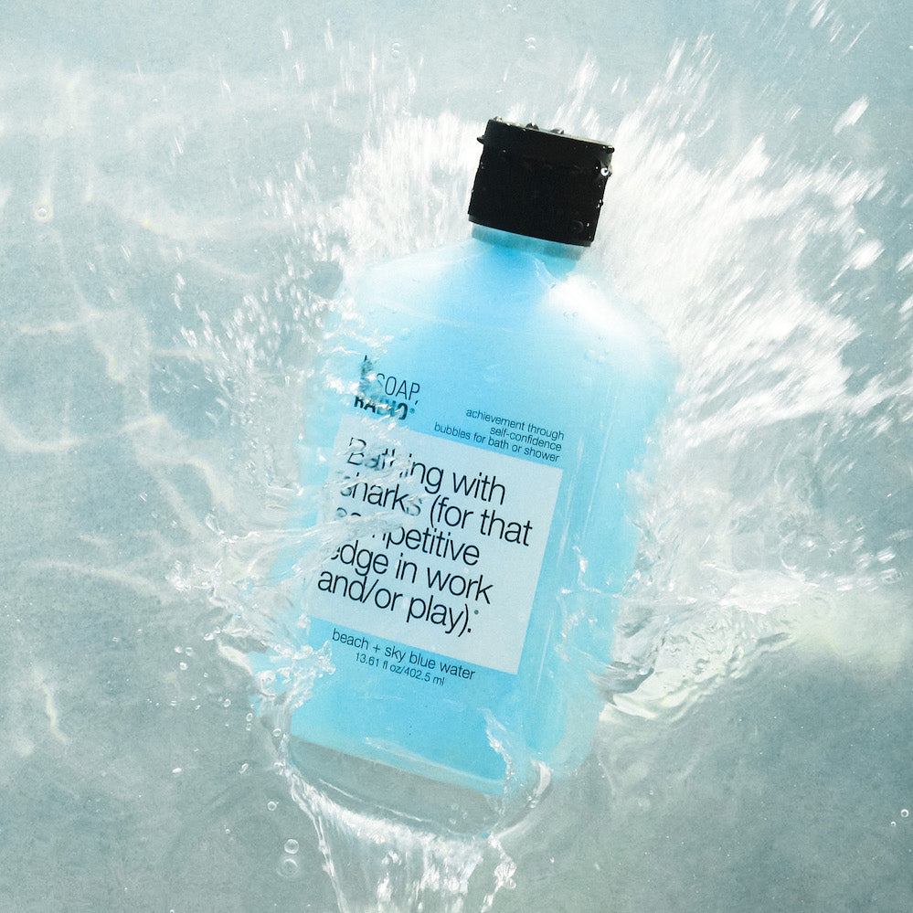 A blue royal jelly extract based shower gel splashing into water.