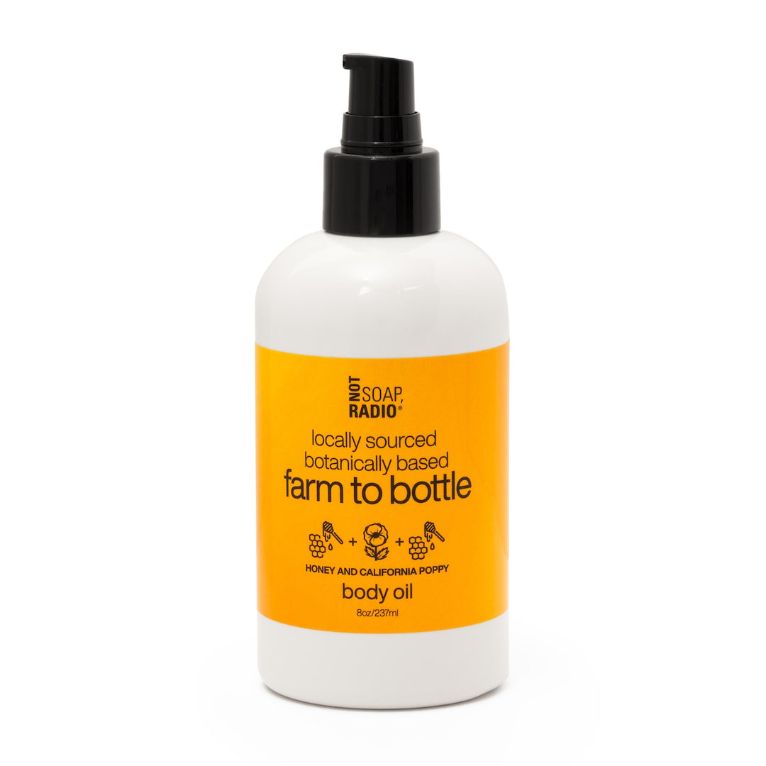 Front of Not Soap Radio Farm to Bottle Honey and California Poppy body oil with pump dispenser, photographed on a white background.