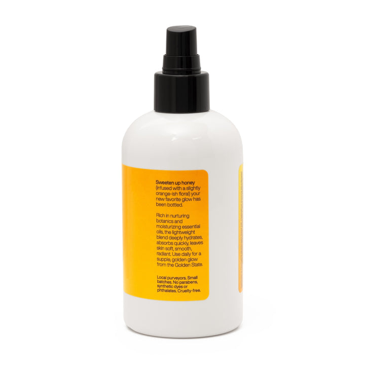 Side of honey scented Farm to Bottle body oil with product description, including focus on local purveyors, small batches. No parabens, synthetic dyes or phthalates. Cruelty-free.