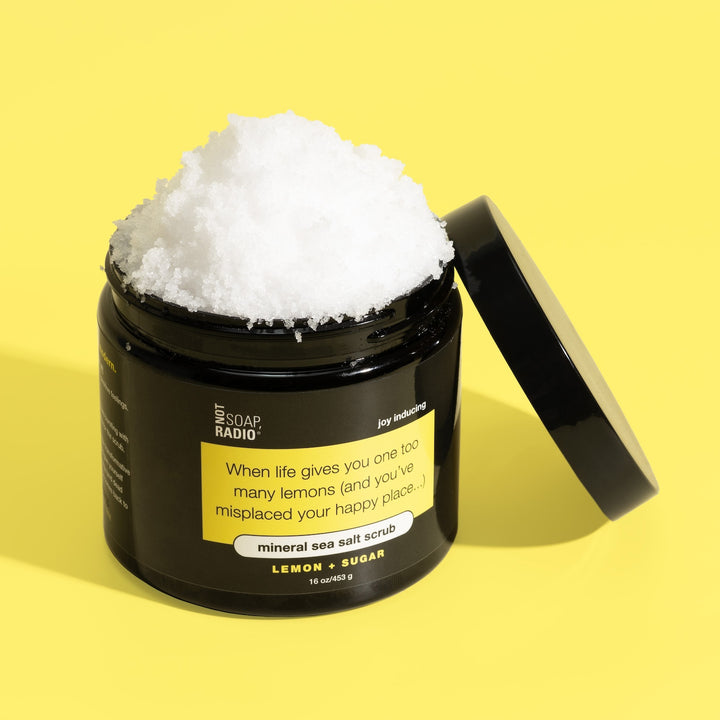 A black 16oz jar of lemon scented sea salt scrub by Not Soap Radio