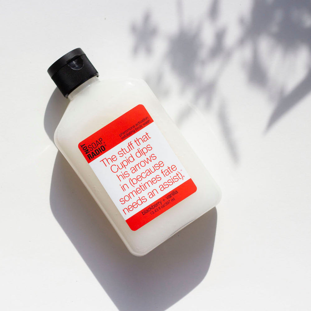 Blackberry vanilla scented exfoliating body wash on a white shadowed background