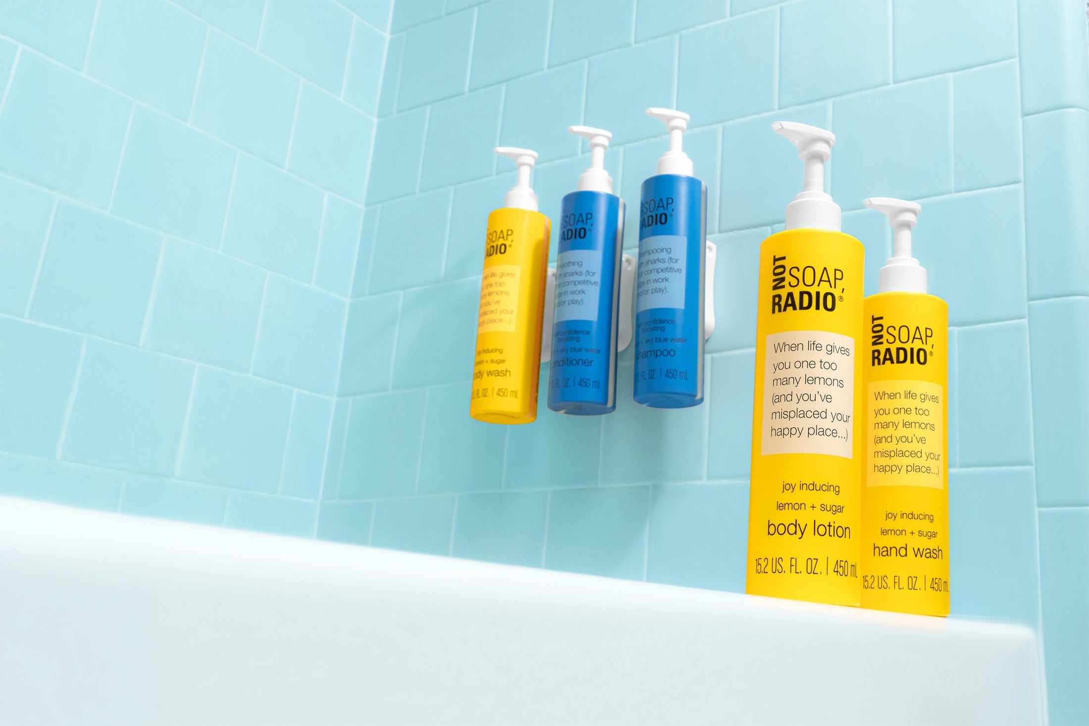 Wall mounted hotel hair and body care, now in a new pump bottle. The entire collection in a blue tiled bath tub