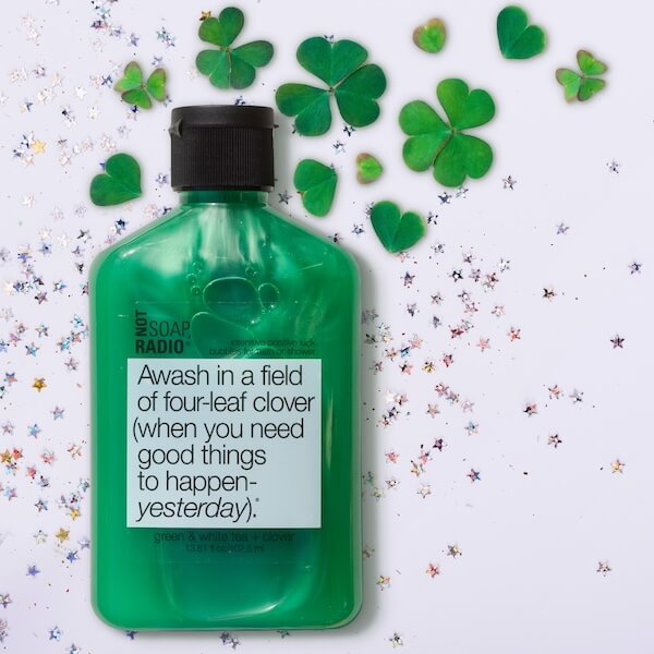 Four-leaf clover good luck bubble bath by Not Soap Radio, surrounded by clover leaves and silver glitter.