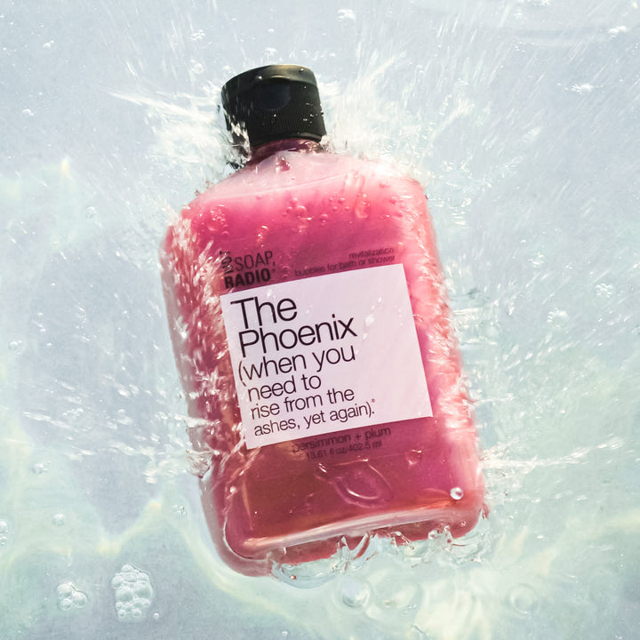 revitalization body wash splashing into a tub of water